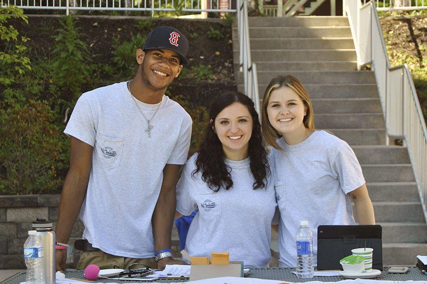 Three students recruit for clubs and organizations